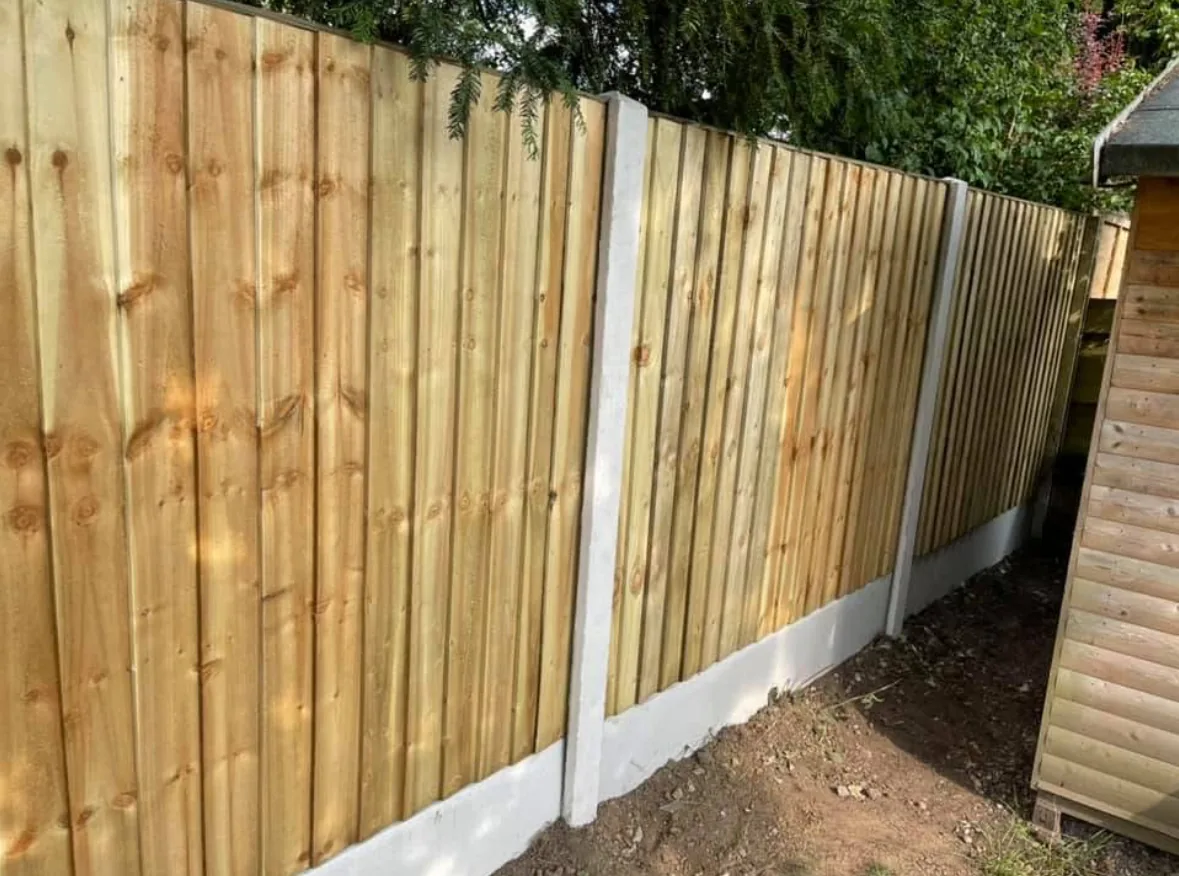 Concrete posts with featherboard fence panels installed by Tatton Fencing